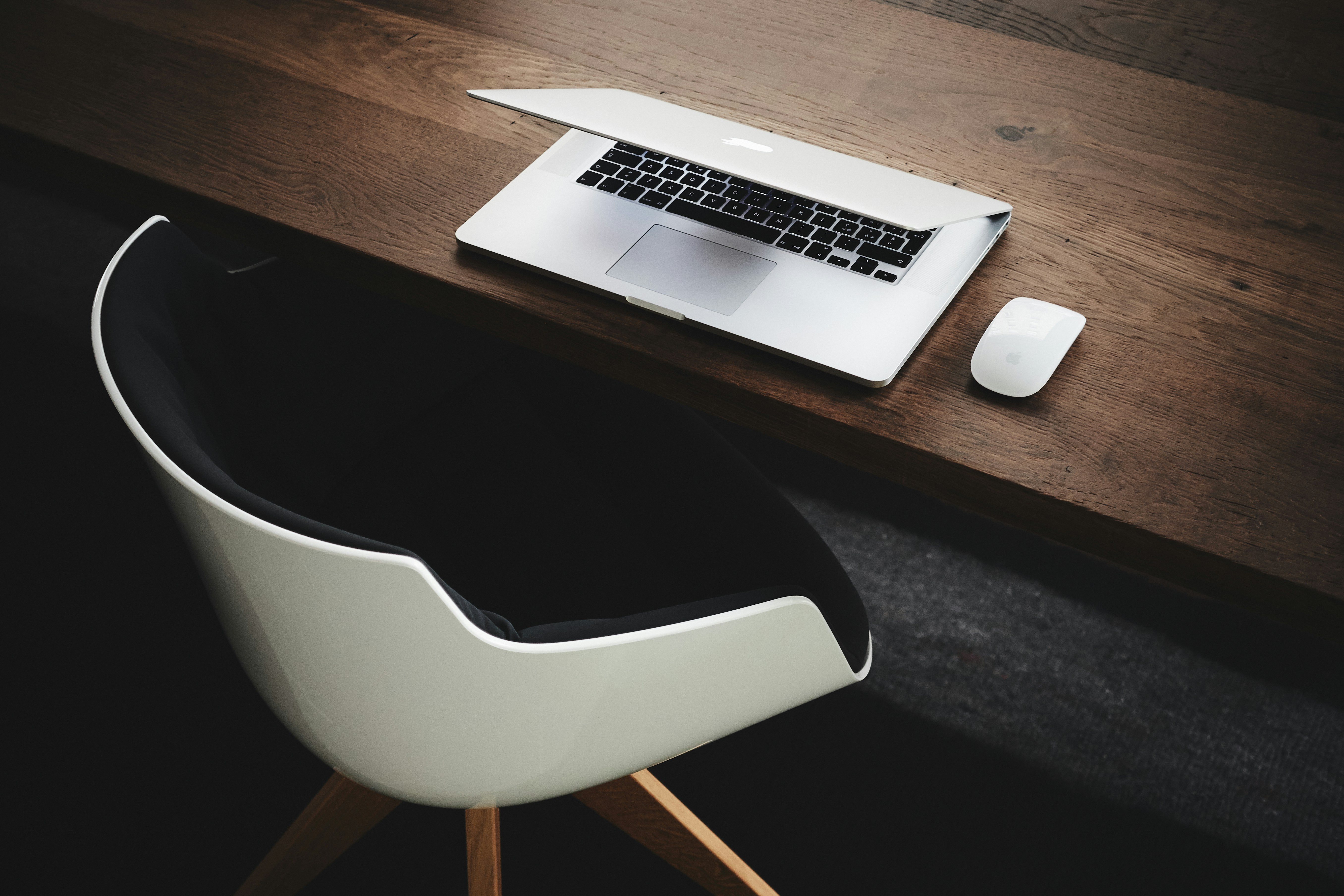 Open laptop computer and notebook with a pen and coffee cup